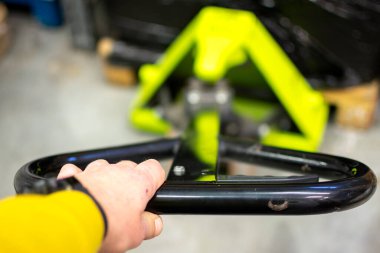 Forklift warehouse worker works with the hand pallet truck safely. Lift and move the pallet loaded with goods.