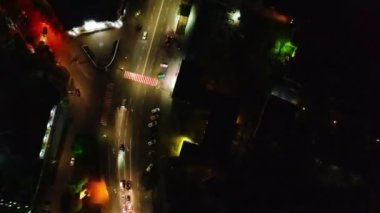 Night city street illuminated crossroad with traffic