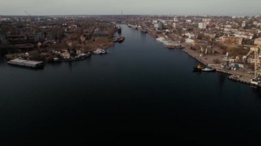 The city of Kherson, Ukraine. Dark long river flows separating parts of city on cloudy day