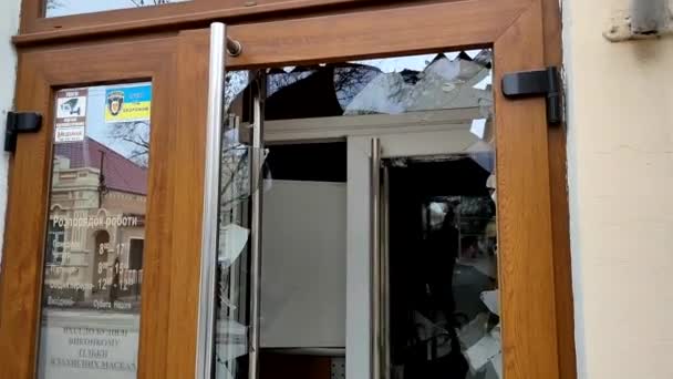 Разбитое стекло двери магазина после нападения вандалов в городе — стоковое видео