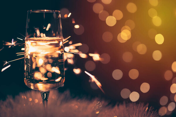 champagne glass with sparkler, festive background, vintage colors