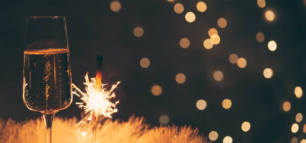 champagne glass with sparkler, festive background, vintage colors