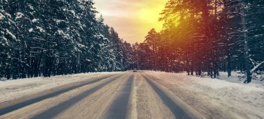 beautiful winter background with a snow-covered forest road