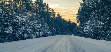 beautiful winter background with a snow-covered forest road