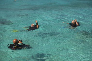 group of tourist snorkeling at open sea 
