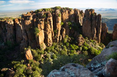 Gün batımında panoramik dağ manzarasında aşınmış kayalar önlükle kaplanır. 