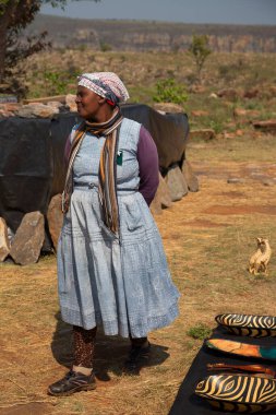 African woman standing on meadow at daytime 