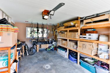 Squamish, British Columbia, Canada - April 2, 2016: An organized indoor house garage storage filled with personal stuff and junk stacked on shelves.
