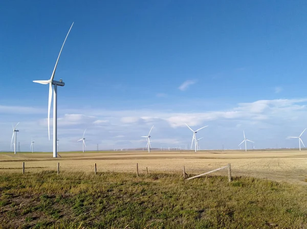 A Canadian prairie landscape with a wind turbine or wind farm near Pincher Creek, Alberta, Canada. The renewable energy, sustainability technology concept.