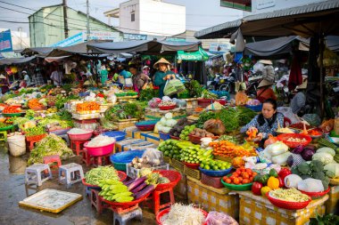 Duong Dong, Phu Quoc Island, Vietnam - January 25, 2018: Vietnamese market vendors selling fresh vegetables at the Duong Dong Market located in Duong Dong, Phu Quoc Island, Vietnam.