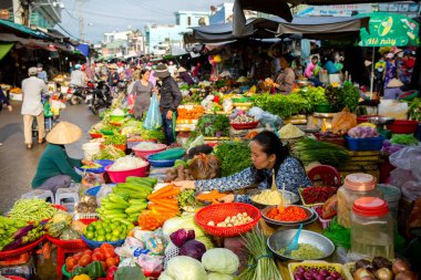 Duong Dong, Phu Quoc Island, Vietnam - January 25, 2018: Vietnamese market vendors selling fresh vegetables at the Duong Dong Market located in Duong Dong, Phu Quoc Island, Vietnam.