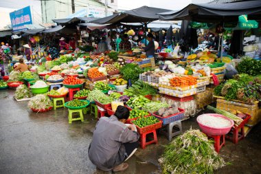 Duong Dong, Phu Quoc Island, Vietnam - January 25, 2018: Vietnamese market vendors selling fresh vegetables at the Duong Dong Market located in Duong Dong, Phu Quoc Island, Vietnam.