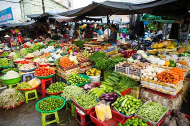 Duong Dong, Phu Quoc Island, Vietnam - January 25, 2018: Vietnamese market vendors selling fresh vegetables at the Duong Dong Market located in Duong Dong, Phu Quoc Island, Vietnam.