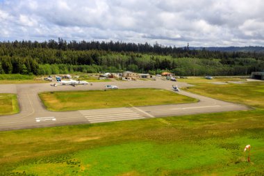 Masset, British Columbia, Canada - June 3, 2022: An aerial view of the runway tarmac of the remote Masset airport located in Haida Gwaii, British Columbia, Canada.