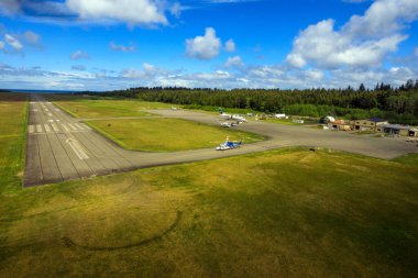 Masset, British Columbia, Canada - June 3, 2022: An aerial view of the runway tarmac of the remote Masset airport located in Haida Gwaii, British Columbia, Canada.