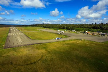 Masset, British Columbia, Canada - June 3, 2022: An aerial view of the runway tarmac of the remote Masset airport located in Haida Gwaii, British Columbia, Canada.
