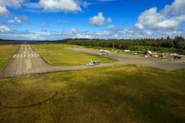 Masset, British Columbia, Canada - June 3, 2022: An aerial view of the runway tarmac of the remote Masset airport located in Haida Gwaii, British Columbia, Canada.