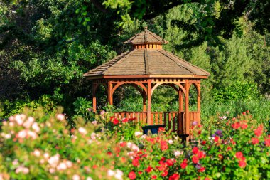 Cedar wooden gazebo at the rose garden in the city park of Penticton, British Columbia, Canada located in the Okanagan Valley.