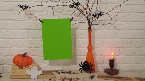 构图与空间之间的文本到Hellobetween 桌子上有一个花瓶 上面有树枝 卡兹哈姆人坐在上面 一支蜡烛在花瓶边燃着 蜘蛛坐着 南瓜躺在盒子里 还有一个鬼魂 — 图库视频影像