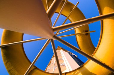 Abstract view of water slike against blue sky. Hotel building in the background. Travel and tourism concept.