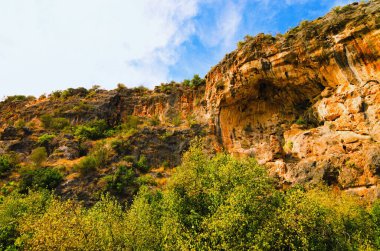 Amazing nature landscape view of Hell and Heaven Cave. There's small cave on bottom. It's one of deepest  sinkholes in Turkey. Blue sky background. Travel and tourism concept.