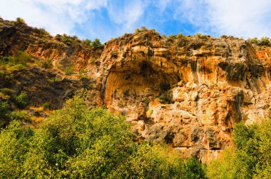 Beautiful wide-angle landscape view of karst sinkhole Cehennem (literature-Heaven cave). It's one of deepest sinkholes in Turkey. Blue sky background. Travel and tourism concept.