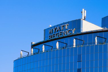 Kyiv, Ukraine-October 10, 2021:Hyatt brandmark on the rooftop of Hyatt Hotel building in the center of Kyiv city. Blue sky background.