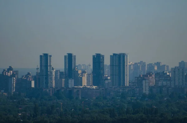 Kyiv cityscape. New residential districts of Kyiv with skyscrapers, aerial view of buildings at morning haze. Natural composition.