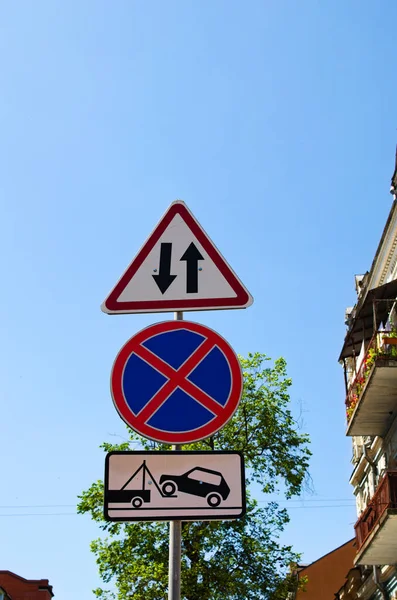Group of traffic signs on the poles. Concept of road sign in big city. Crosswalk and Dead end signs. Two way traffic, No Stopping and Tow truck is working traffic signs.