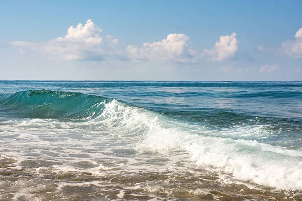 Background image of the beauty of the sea element is a mass of sea waves rolling ashore with caps of white foam.