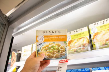 Los Angeles, California, United States - 03-18-2021: A view of a hand holding a box of Blake's gluten-free mac and cheese, on display at a local grocery store.