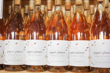 Los Angeles, California, United States - 04-06-2021: A view of several bottles of Paper Planes rose wine, on display at a local grocery store.