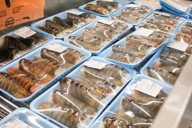 Los Angeles, California, ABD - 04-06-2021: Yerel bir Costco mağazasında sergilenen Kirkland imzalı birkaç paket ıstakoz kuyruğu manzarası.