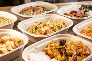 A view of several fast casual pan Asian rice and noodles bowls.