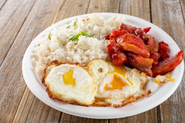 Bir tabak kızarmış yumurta ve tocino manzarası.