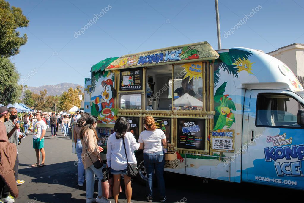 Pasadena, California, United States - 10-25-2021: A view of people buying snow cones from a food truck vendor known as Kona Ice.