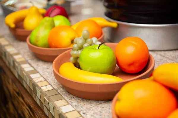 View Several Terra Cotta Dishes Holding Plastic Fruit — Stock Photo, Image