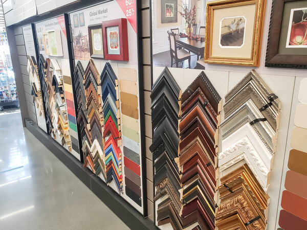 Los Angeles, California, United States - 04-26-2021: A view of a frame pieces and samples on a wall facade, on display at a local arts and crafts store.