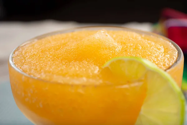 A closeup view of the texture of a frozen margarita beverage.