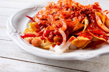 A view of a plate of tostilocos. clipart