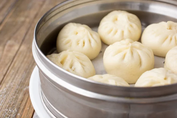 A view of a container of Chinese steamed buns, also known as baozi.