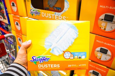 Tustin, California/United States - 02/08/2020: A hand holds a pack of Swiffer duster refill pads on display at a local big box grocery store.