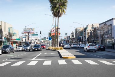 Belmont Shore, California/United States - 02/12/2020: A view from the middle of the street of traffic going through downtown Belmont Shore, on 2nd Street.