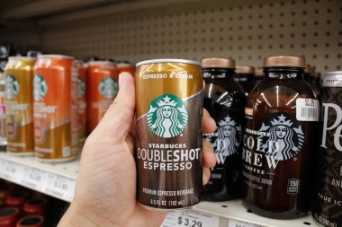 Long Beach, California, United States - 02-12-2020: A hand holds a can of Starbucks Doubleshot Espresso coffee beverage on display at a local grocery store.