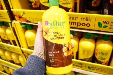 Garden Grove, California, ABD - 02-132020: Alba Botanica Mega Nem Şampuanı şişesini tutan bir elin görüntüsü.