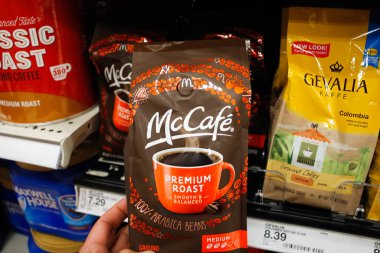 Alhambra, California/United States - 02/19/2020: A hand holds a package of McCafe Premium Roast coffee beans, on display at a local grocery store.