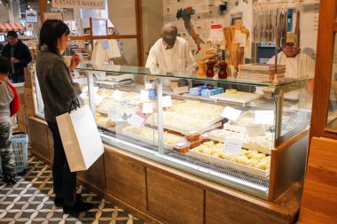 Los Angeles, California/United States - 02/23/2020: A customer orders freshly made pasta at the counter, inside the marketplace known as Eataly.