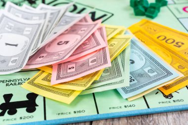 Los Angeles, California, ABD - 05-07-2020: Monopoly oyununun renk koordineli para biriminin yakın görüntüsü. Para oyun tahtasına rastgele yığılmış..