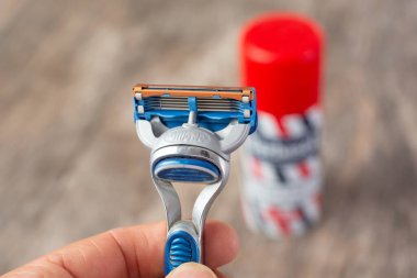 Los Angeles, California, United States - 04-30-2020: A closeup view of a Gillette razor blade in front of a Barbasol shaving cream can.