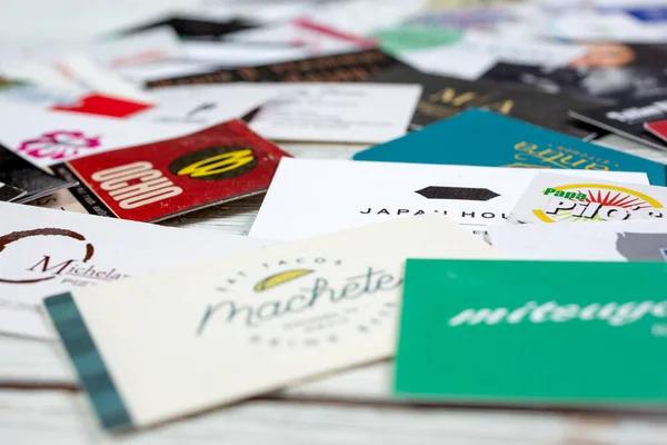 Los Angeles, California/United States - 02/06/2020: A closeup view of a collection of several business cards. 